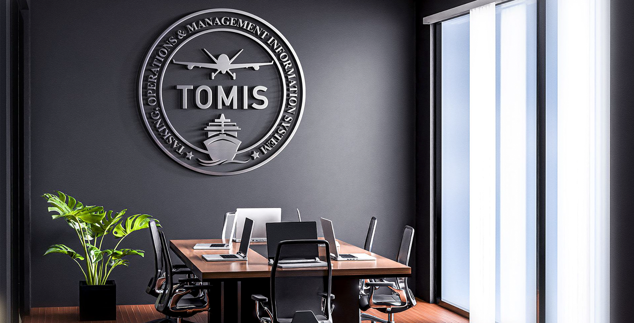 TOMIS dimensional wall emblem in a modern office conference room